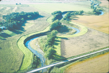 A grass filter strip and forested riparian buffer used to protect a stream from agricultural non point source pollution. Lynn Betts / Photo courtesy of USDA Natural Resources Conservation Service.  Filter strip along a stream in western Iowa.